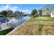 A serene view of the waterfront property, showcasing canal access, boat docks, and lush green lawn at 13928 Raie Ave, Hudson, FL 34667