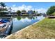 Scenic waterfront view features canal access, boats, docks, clear skies and lush greenery surrounding the property at 13928 Raie Ave, Hudson, FL 34667