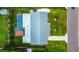Aerial view of the property showcasing the house, backyard, patio, hot tub, and surrounding landscape in a residential neighborhood at 13978 Barbados Dr, Seminole, FL 33776