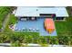 Aerial view of the property showcasing the patio with outdoor seating, hot tub, fire pit, and surrounding landscape at 13978 Barbados Dr, Seminole, FL 33776