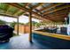 A large covered outdoor living area with grill, seating, and a hot tub at 13978 Barbados Dr, Seminole, FL 33776