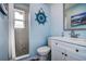 Bright bathroom with a shower, marble look tiles, and a white vanity with modern fixtures at 13978 Barbados Dr, Seminole, FL 33776
