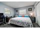 Comfortable bedroom features two windows, starfish patterned linens, and ocean themed decor at 13978 Barbados Dr, Seminole, FL 33776