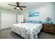 This is a bedroom with a ceiling fan, a double closet, and matching night stands at 13978 Barbados Dr, Seminole, FL 33776