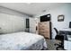 This bedroom has an accent wall, a mounted TV, and a view into the next room at 13978 Barbados Dr, Seminole, FL 33776