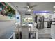 Open-concept dining area with gray plank floors, adjacent to a modern kitchen with stainless steel appliances at 13978 Barbados Dr, Seminole, FL 33776