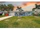 Charming single-story home with a well-manicured lawn and a welcoming front porch at 13978 Barbados Dr, Seminole, FL 33776