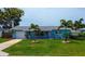Inviting single-Gathering home featuring a beautifully landscaped front yard and boat on trailer at 13978 Barbados Dr, Seminole, FL 33776
