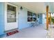 Welcoming front porch with chairs and beach-themed decor at 13978 Barbados Dr, Seminole, FL 33776