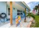 Close-up of the cozy front porch with beach decor accents at 13978 Barbados Dr, Seminole, FL 33776