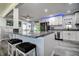 Open kitchen with granite countertops, stainless steel appliances and bar stool seating at 13978 Barbados Dr, Seminole, FL 33776