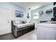 A beach themed laundry room with a daybed, decor, storage and a window at 13978 Barbados Dr, Seminole, FL 33776