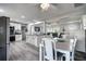 Open floorplan with dining area, kitchen, and living room featuring light gray plank flooring and modern finishes at 13978 Barbados Dr, Seminole, FL 33776
