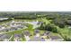 Community aerial view of the house with a pond and green surroundings at 14063 Wineberry Dr, Dade City, FL 33525