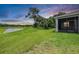 Expansive backyard with lush green grass and scenic water views; perfect for outdoor enjoyment at 14063 Wineberry Dr, Dade City, FL 33525