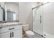 Bathroom features a modern glass shower and granite countertop with white cabinets at 14063 Wineberry Dr, Dade City, FL 33525