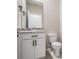 This half-bathroom includes a modern vanity with a toilet at 14063 Wineberry Dr, Dade City, FL 33525