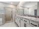 Bathroom features double vanity with granite countertop, modern fixtures and glass shower at 14063 Wineberry Dr, Dade City, FL 33525