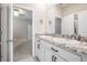 Elegant bathroom features a double sink vanity with a granite countertop at 14063 Wineberry Dr, Dade City, FL 33525