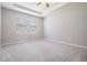 Spacious bedroom features neutral walls, plush carpet, and natural light from two large windows at 14063 Wineberry Dr, Dade City, FL 33525