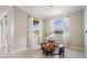 Cozy dining area with unique wooden table and bench seating, surrounded by bright windows at 14063 Wineberry Dr, Dade City, FL 33525