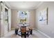 Bright dining area featuring unique wooden table and bench seating near sun-filled windows at 14063 Wineberry Dr, Dade City, FL 33525