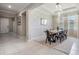 Inviting dining room with tray ceiling, decorative wallpaper, and plenty of natural light at 14063 Wineberry Dr, Dade City, FL 33525