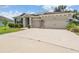A spacious home with a multi-car driveway and tasteful stone accents at 14063 Wineberry Dr, Dade City, FL 33525