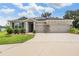 Beautiful home with a spacious driveway, stone accents, and solar panels on the roof at 14063 Wineberry Dr, Dade City, FL 33525
