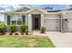 Charming home featuring a well-manicured lawn and a convenient single-car garage at 14063 Wineberry Dr, Dade City, FL 33525