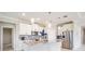 Bright kitchen features an island with granite countertops, pendant lighting, and stainless appliances at 14063 Wineberry Dr, Dade City, FL 33525