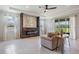 Comfortable living room featuring a modern fireplace, recessed lighting, and sliding glass doors at 14063 Wineberry Dr, Dade City, FL 33525