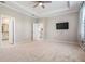Bright main bedroom with en-suite bath, carpet flooring, and ceiling fan at 14063 Wineberry Dr, Dade City, FL 33525