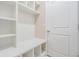 Well-organized mudroom features white shelving, storage, and a convenient bench at 14063 Wineberry Dr, Dade City, FL 33525