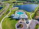 Aerial view of lakefront community with clubhouse, pool, playground and walking trails at 14206 Covert Green Pl, Riverview, FL 33579