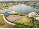 Aerial view of community playground area next to a pond at 14206 Covert Green Pl, Riverview, FL 33579