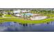 Aerial view of community pool area with a pond and manicured landscaping at 14206 Covert Green Pl, Riverview, FL 33579