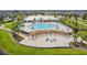 Overhead view of community pool featuring chairs, pergolas, and landscaped paths at 14206 Covert Green Pl, Riverview, FL 33579