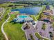 Aerial view of community with clubhouse, pool, and lake at 14206 Covert Green Pl, Riverview, FL 33579