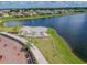 Aerial view of lakefront amphitheater and park with walking trails at 14206 Covert Green Pl, Riverview, FL 33579