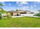 Expansive backyard with a patio area, green lawn, white fence offering privacy, and room for recreation at 14206 Covert Green Pl, Riverview, FL 33579