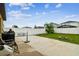 Spacious backyard featuring a concrete patio, well-maintained lawn, and a white fence at 14206 Covert Green Pl, Riverview, FL 33579