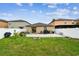 Spacious backyard with a concrete patio, green lawn, fire pit and white vinyl fence at 14206 Covert Green Pl, Riverview, FL 33579