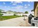 Large backyard with a concrete patio, fire pit, and green lawn perfect for outdoor entertaining at 14206 Covert Green Pl, Riverview, FL 33579