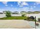 Landscaped backyard featuring a fire pit, flowers, lawn, and outdoor seating area with a white fence at 14206 Covert Green Pl, Riverview, FL 33579