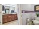 Bathroom with a double sink vanity with decorative countertop and adjacent toilet at 14206 Covert Green Pl, Riverview, FL 33579
