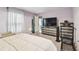 Bedroom with lilac walls, white curtains, a TV, and a closet at 14206 Covert Green Pl, Riverview, FL 33579