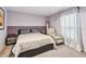 Bedroom with purple accent wall, a ceiling fan, and a chair by the window at 14206 Covert Green Pl, Riverview, FL 33579