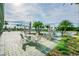 The community pool is surrounded by tables, chairs, umbrellas, and palm trees for a fun community atmosphere at 14206 Covert Green Pl, Riverview, FL 33579