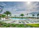 Resort-style community pool with lounge chairs and palm trees for a relaxing experience at 14206 Covert Green Pl, Riverview, FL 33579